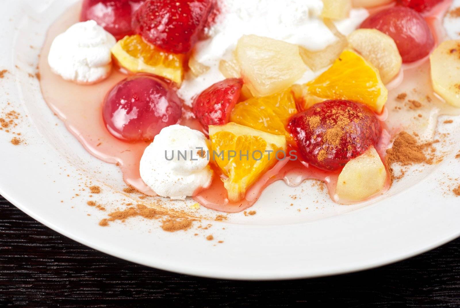 fruit salad of pineapple, grape, orange and strawberry with whipped cream