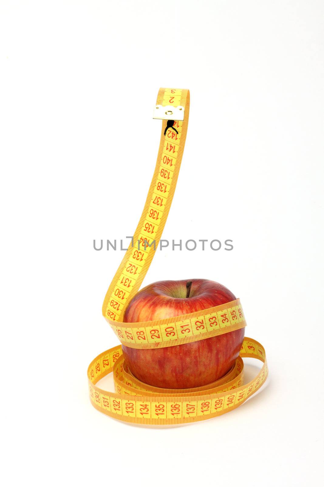 Diet concept.Apple and measure like a snake over white