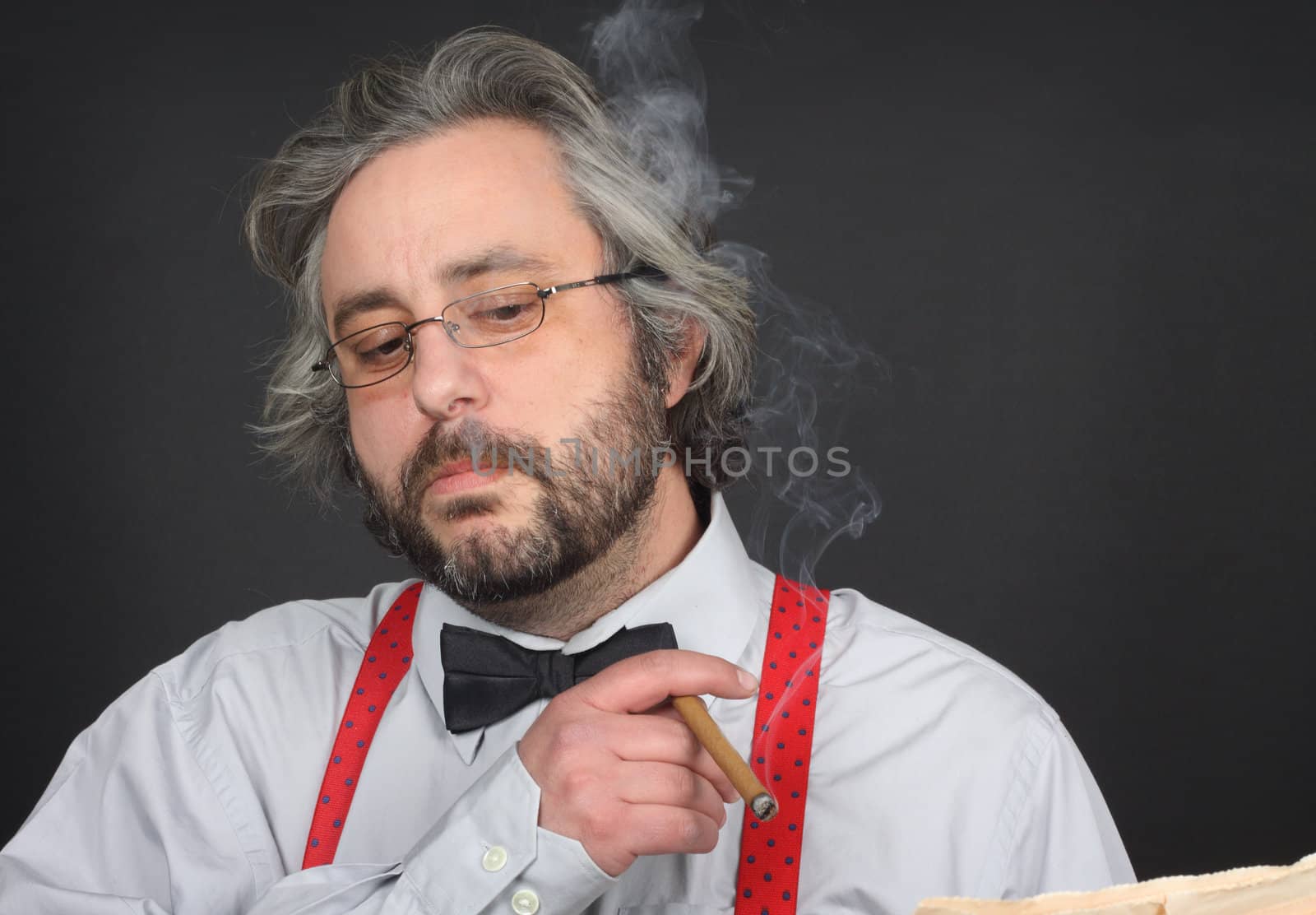 Bearded man with bow tie smoking cigar