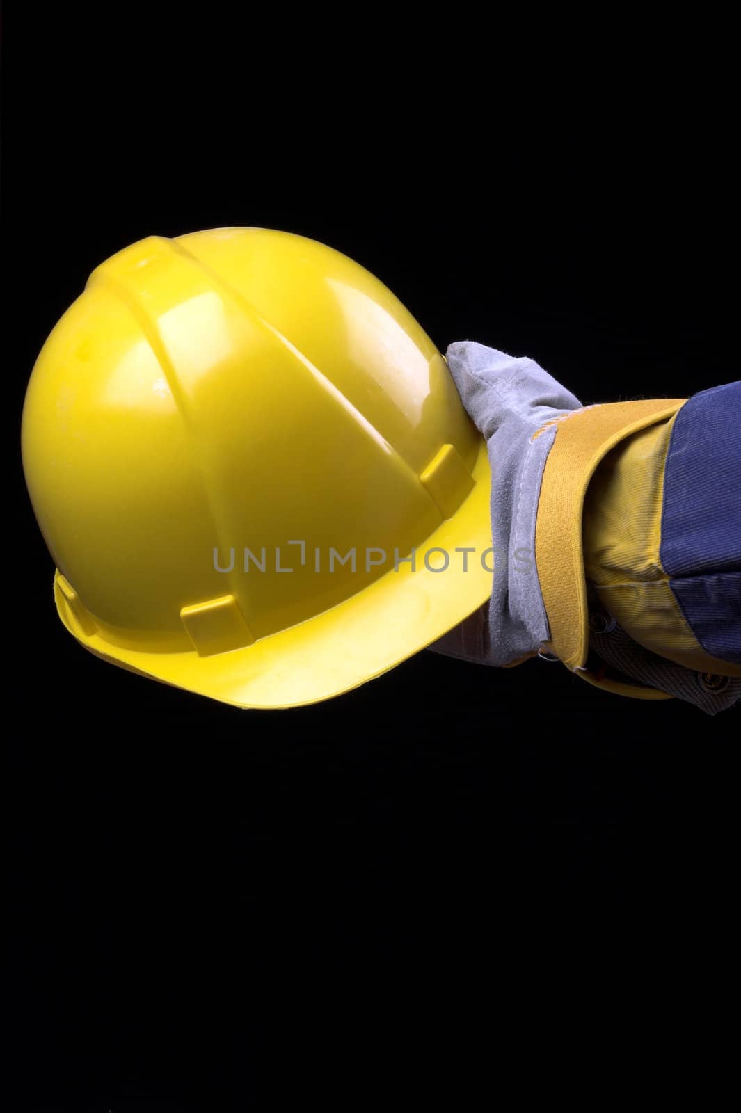 man holding yellow helmet over black

