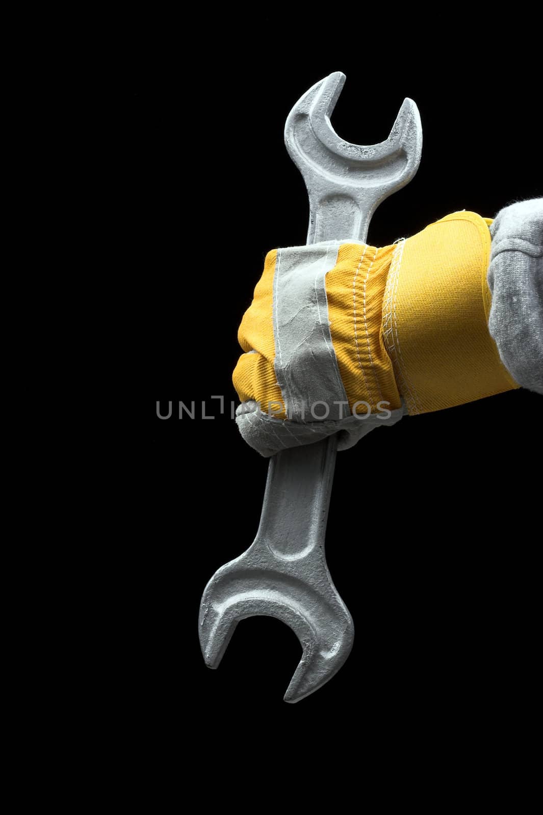  man holding a big wrench over black
