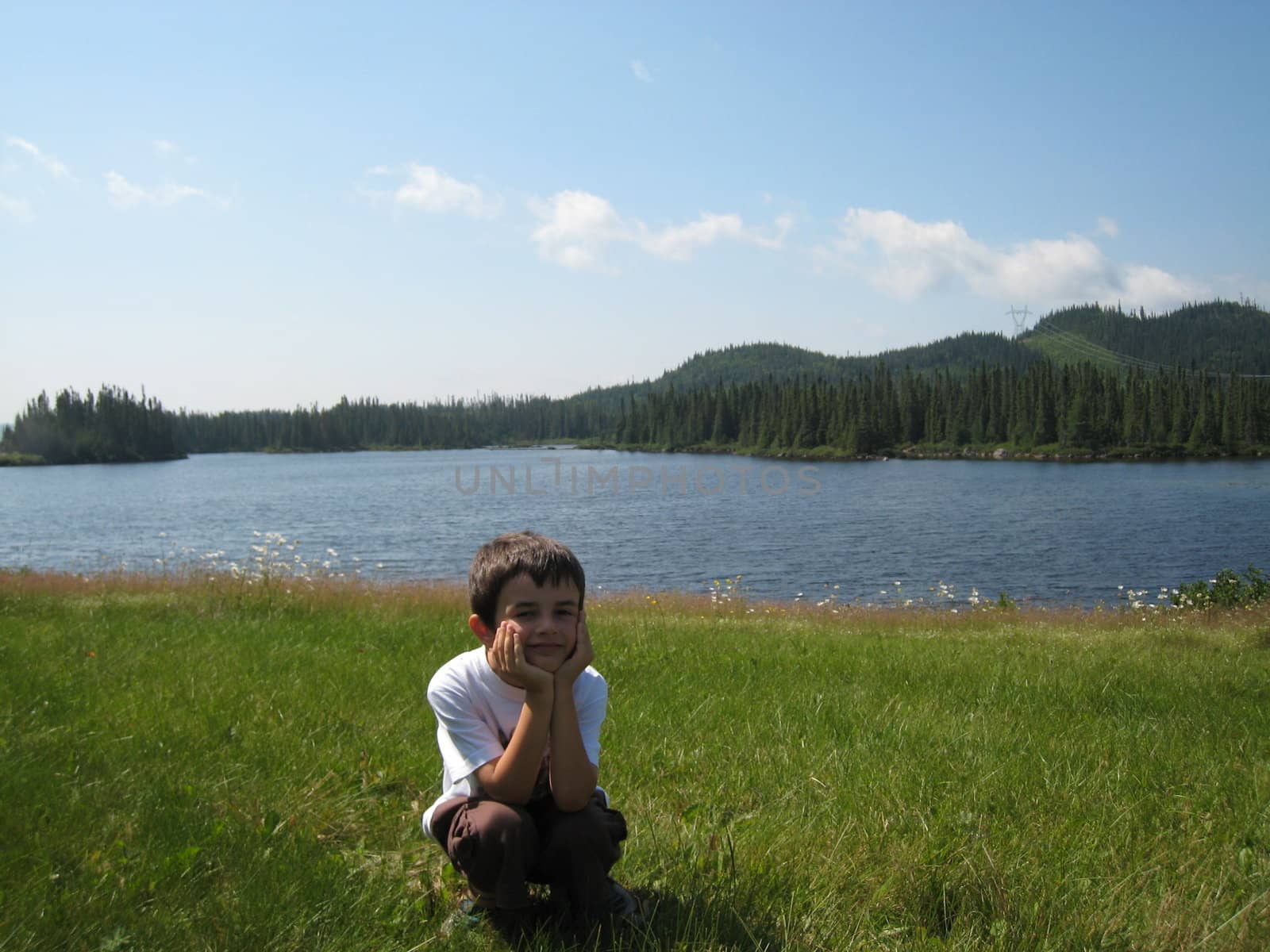 boy posing in front of a lake in Mauricie, Quebec