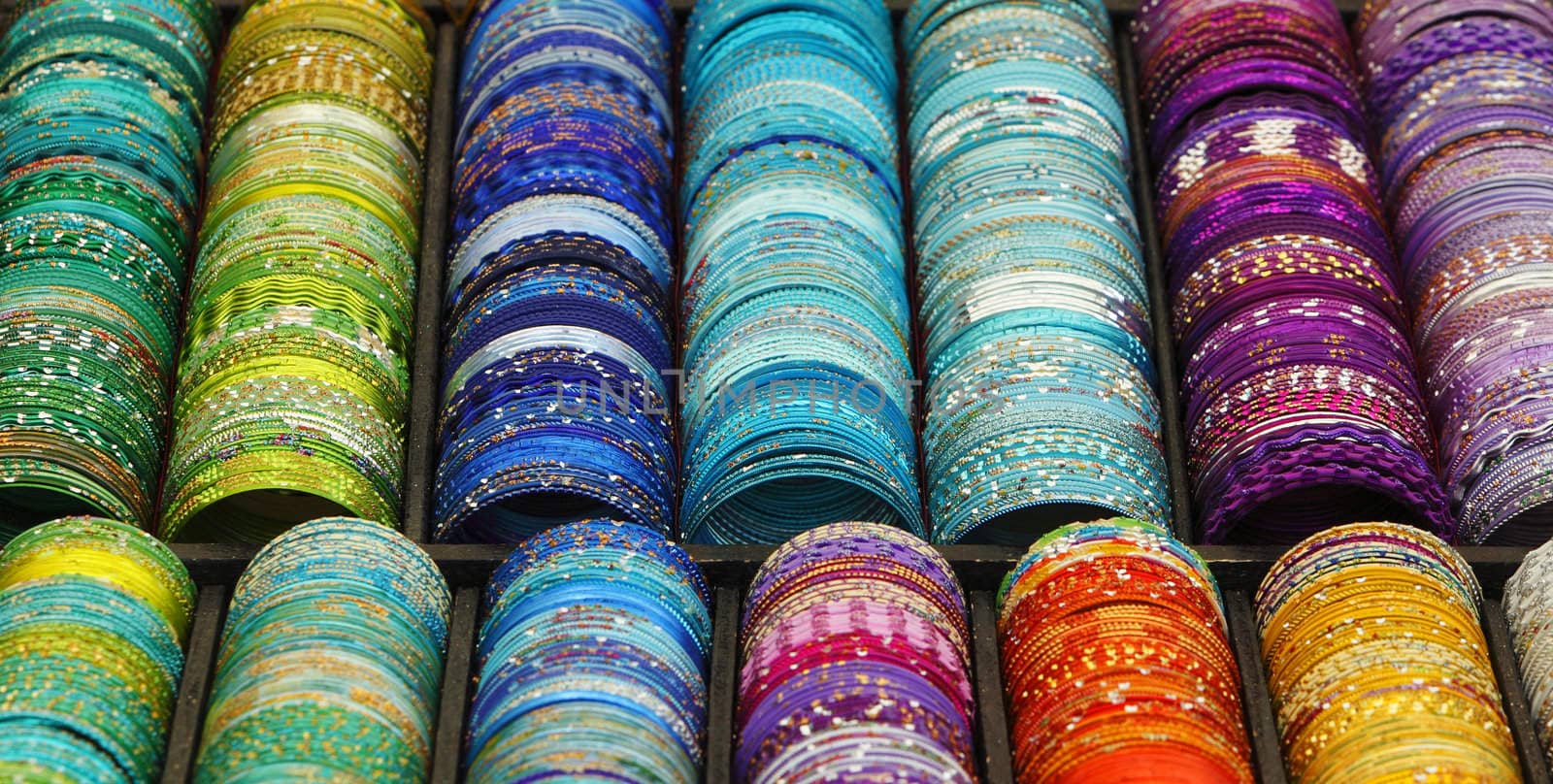 Detail of a stand with various colorful bracelets.