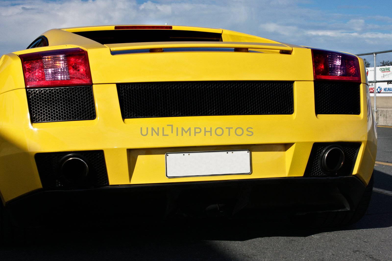 Back view of a yellow sports car