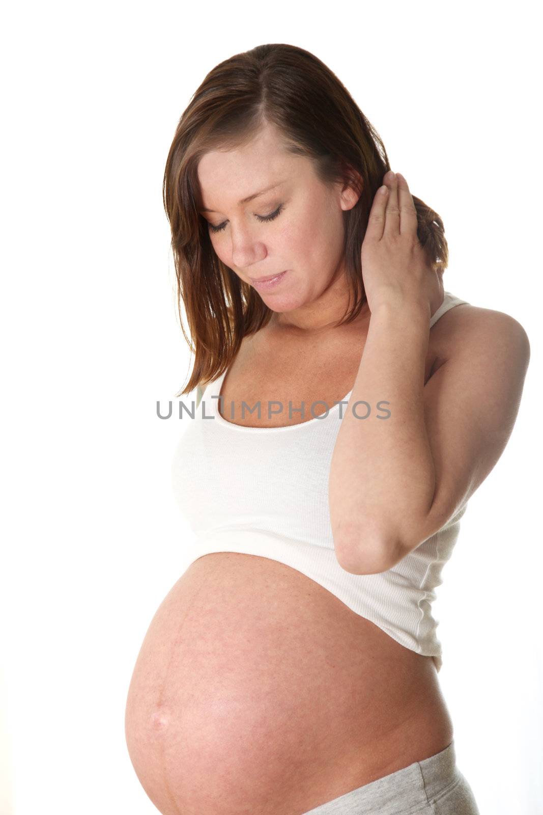 Pregnant women, young woman against a white background looks happy on her belly