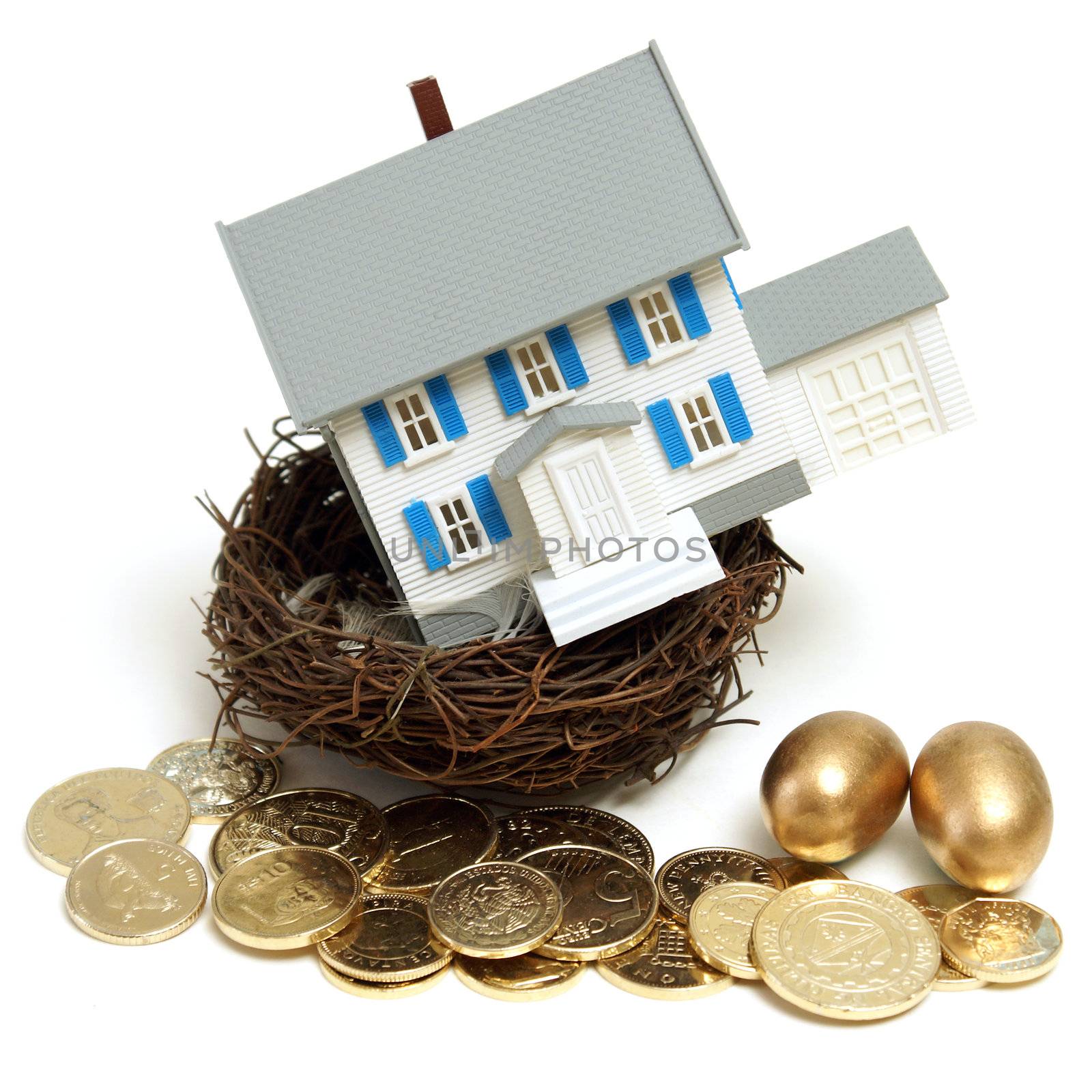 A house in a nest with golden eggs and coins for many conceptual ideas.