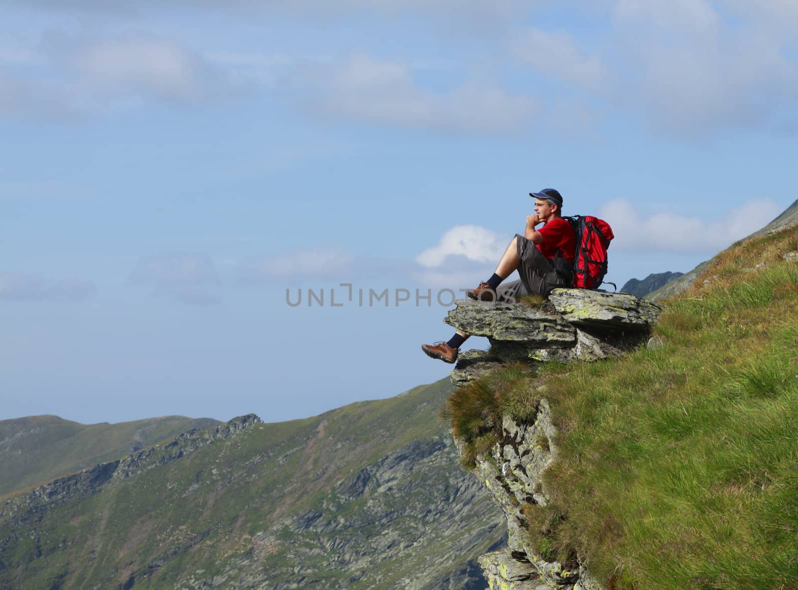 Man scrutinizing the horizon in mountains.