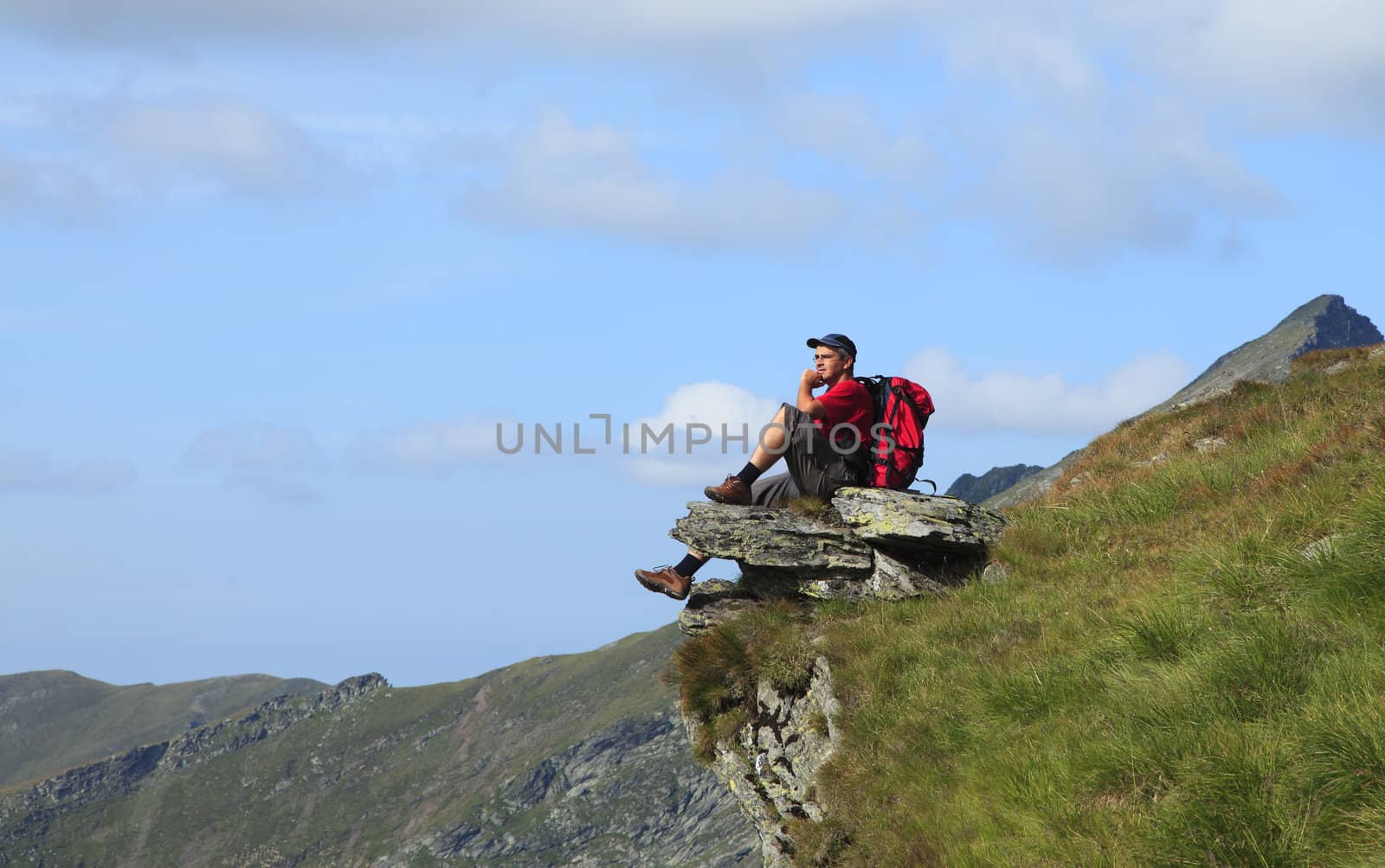 Man scrutinizing the horizon in mountains.