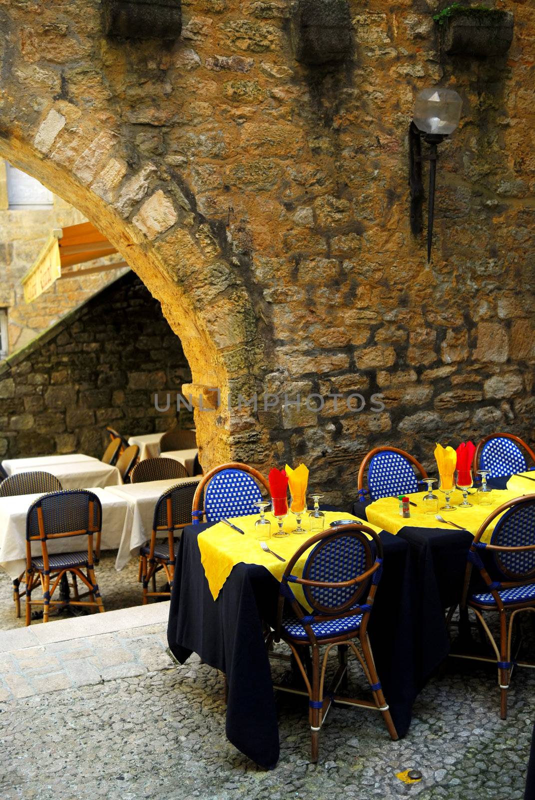 Restaurant patio among medieval walls in Sarlat, Dordogne region, France