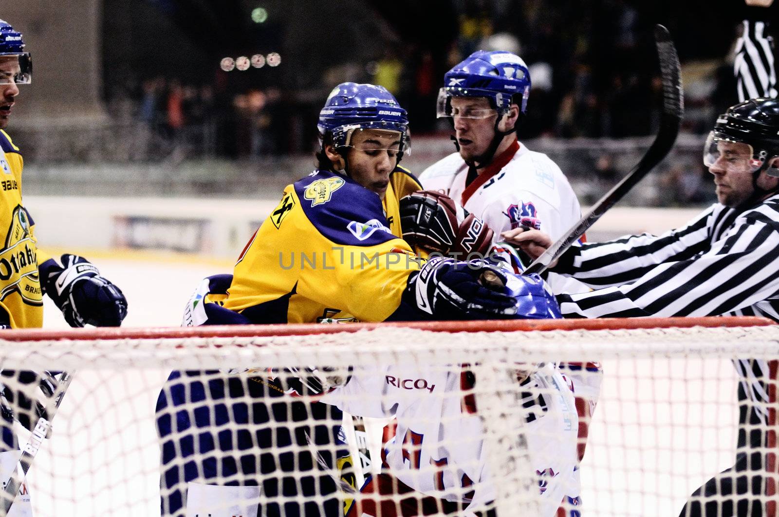 ZELL AM SEE, AUSTRIA - FEB 1: Austrian National League. Putnik punches Graz player. Game EK Zell am See vs. ATSE Graz (Result 4-1) on February 1, 2011, at hockey rink of Zell am See