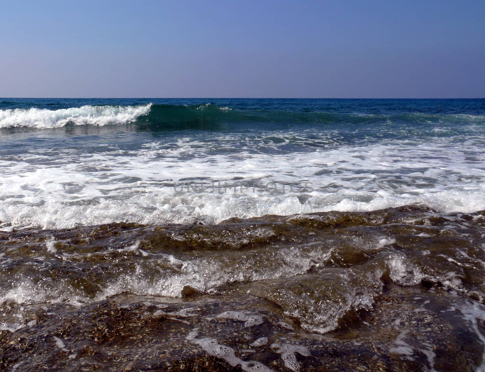 Waves with white foam in the mediterranean sea