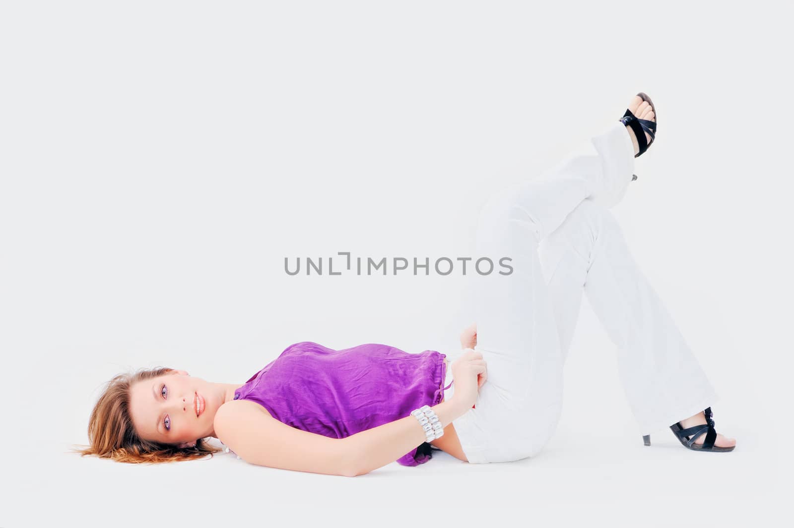 Young woman resting supine. Isolated on white background