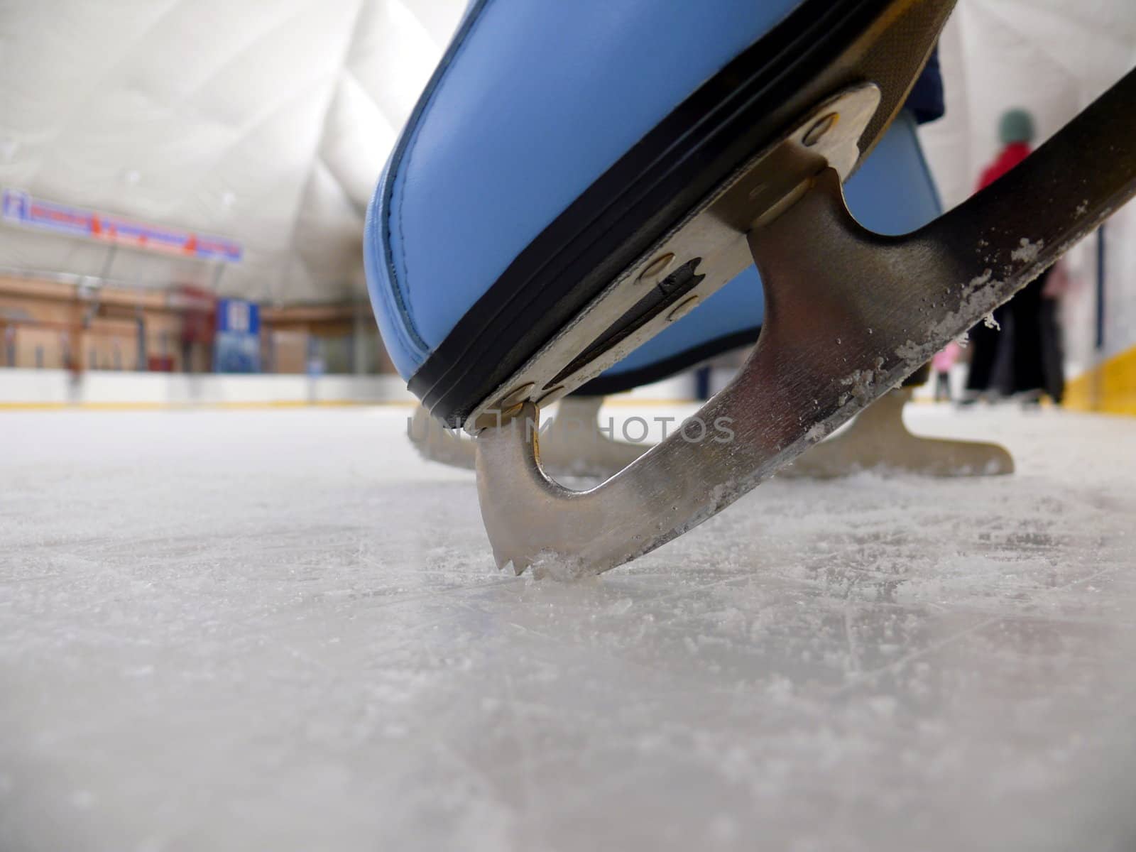 Blue figure skate in the ice