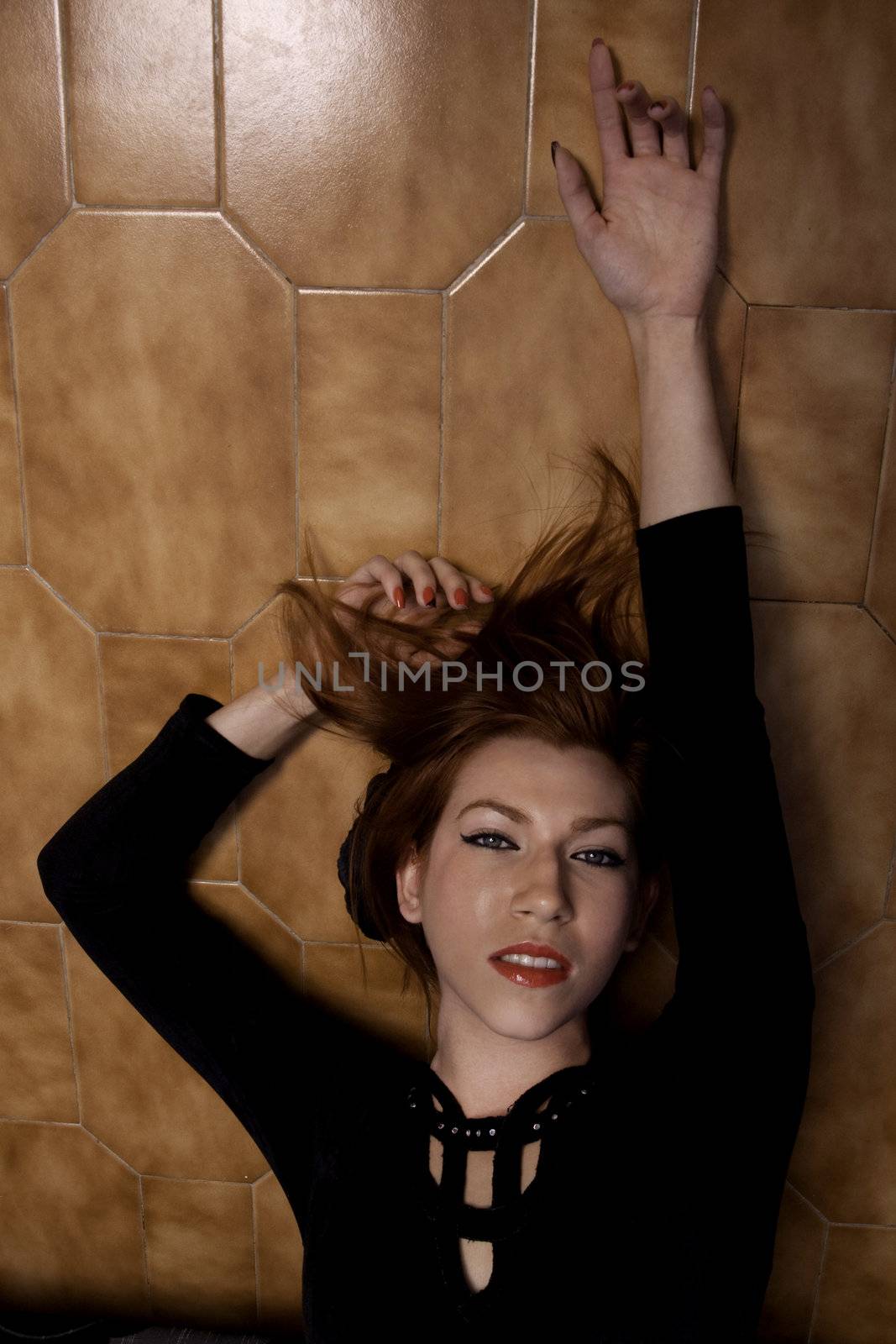 View of a beautiful woman on a sensual pose on the floor.