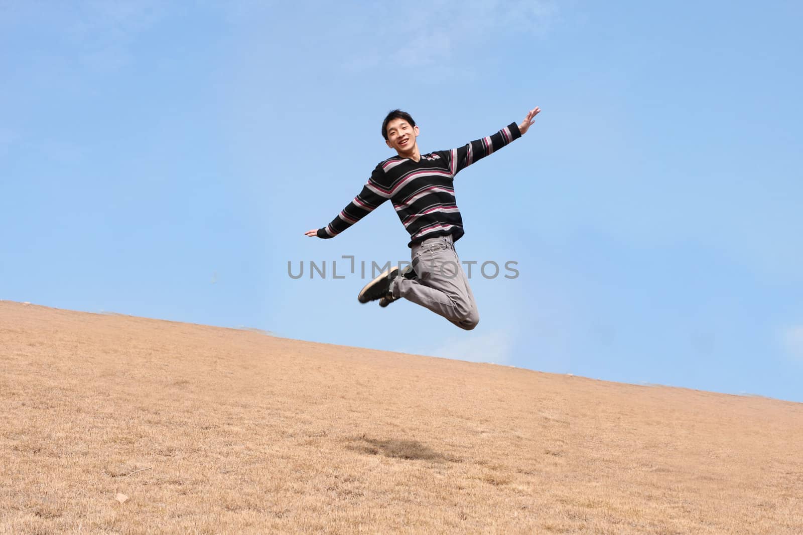 Happy jumping man on winter day 