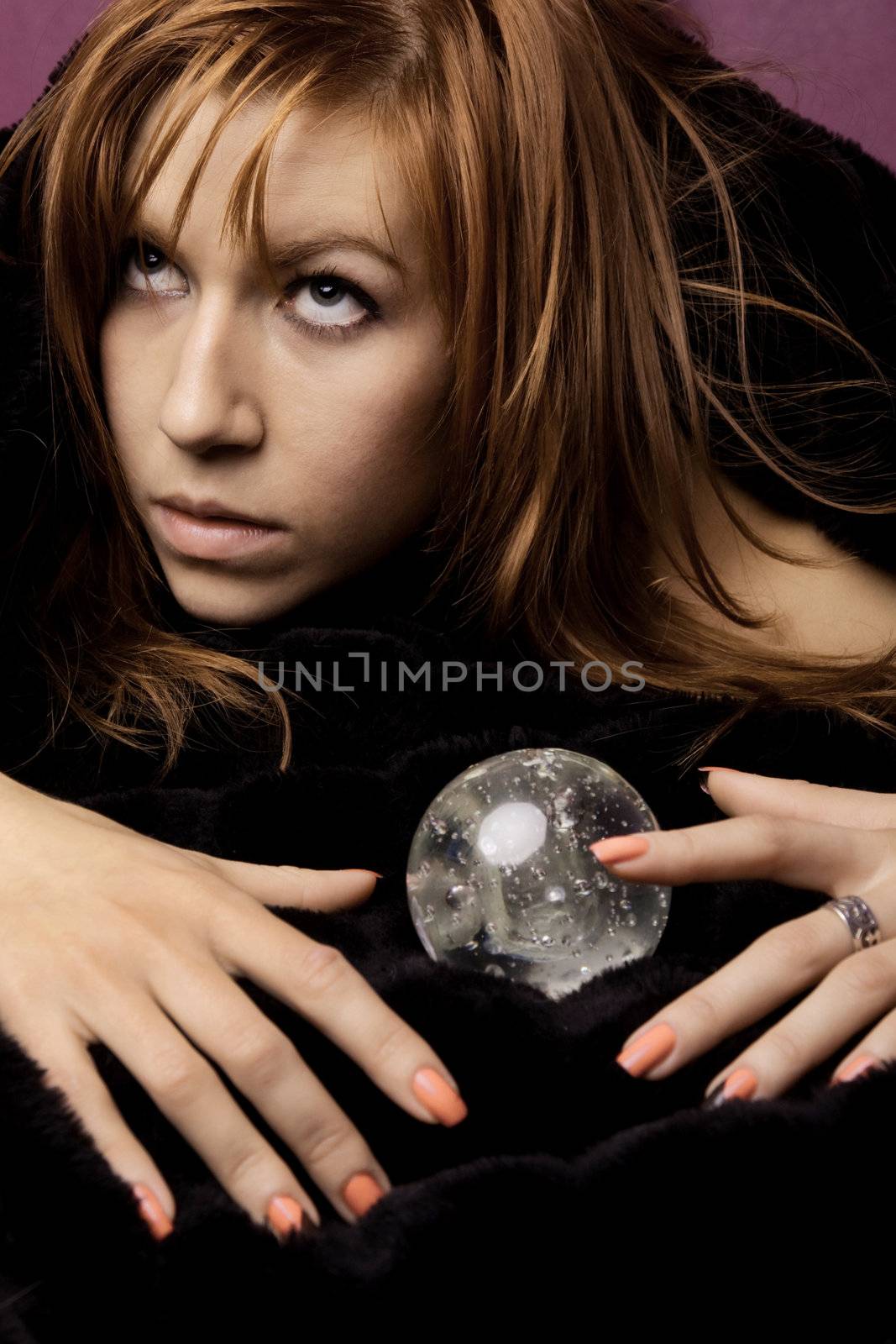 View of a beautiful woman on the bed with a transparent glass ball.