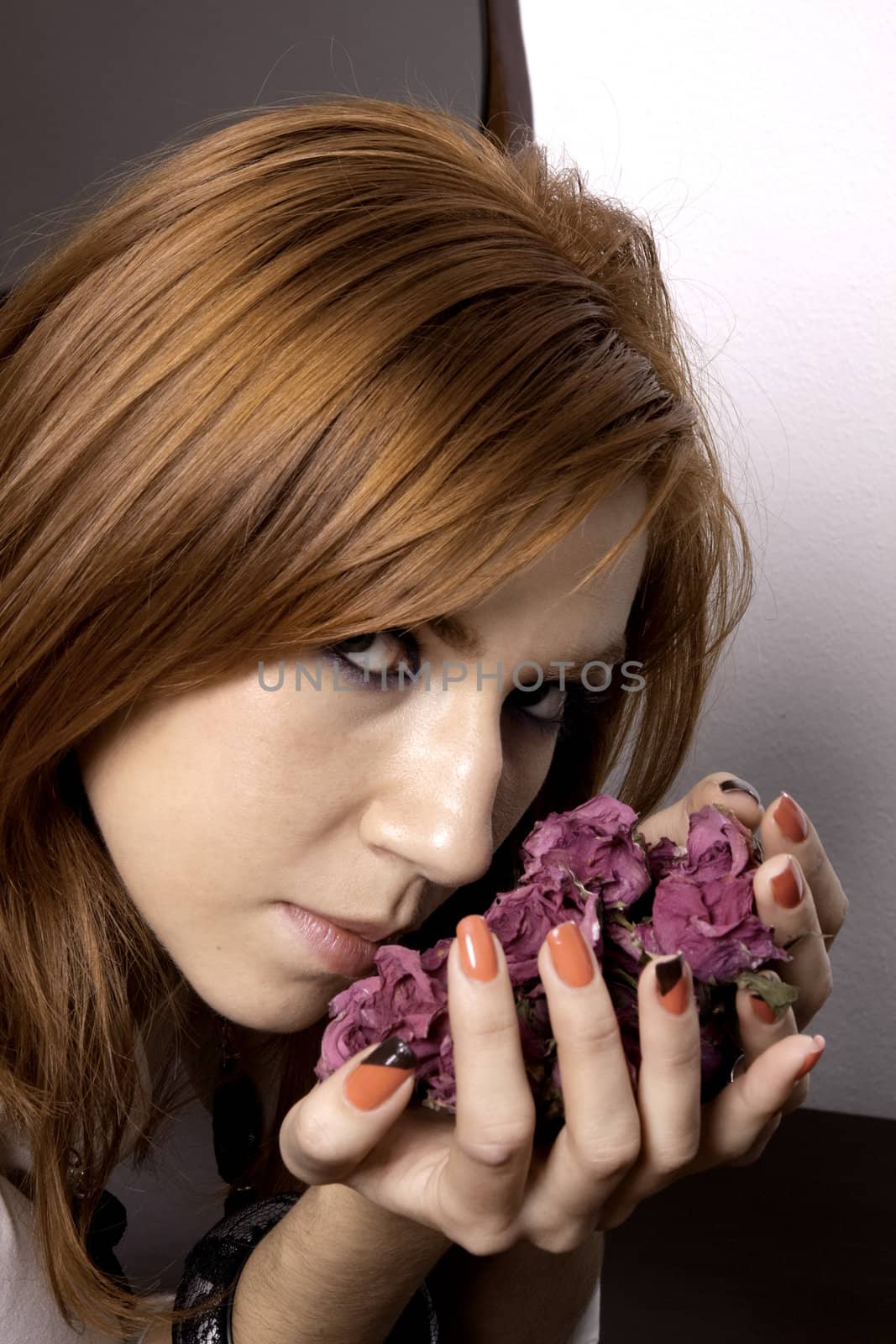 View of a beautiful woman offering a plate full of lifeless roses.