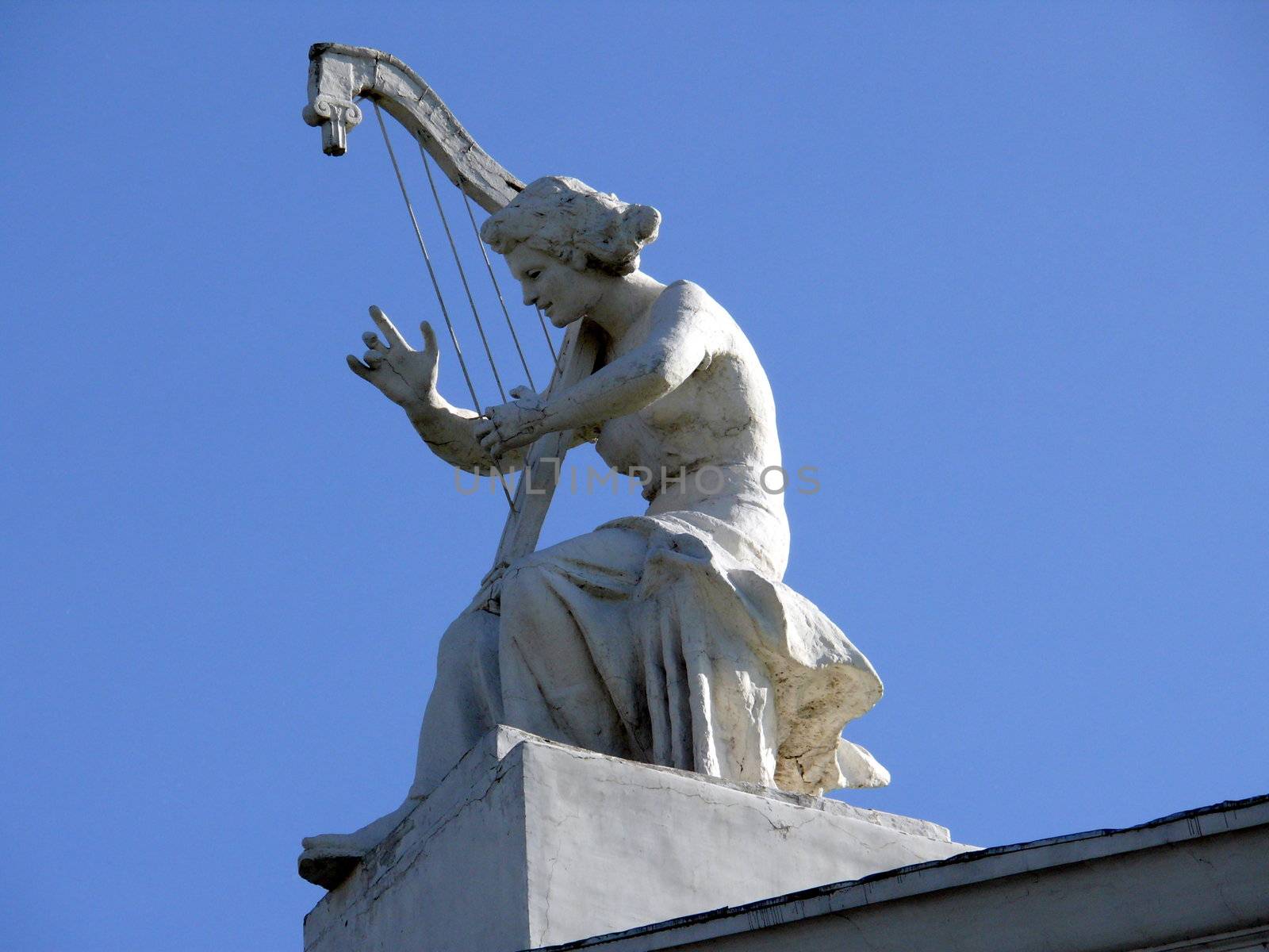Sculpture of woman with harp in the roof