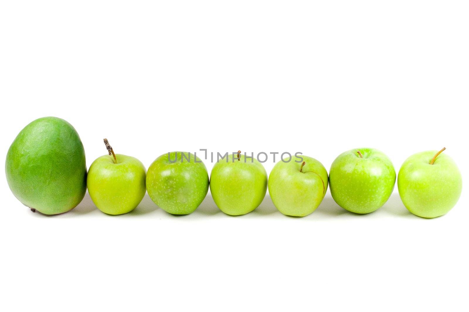 Shot of row apples and one mango