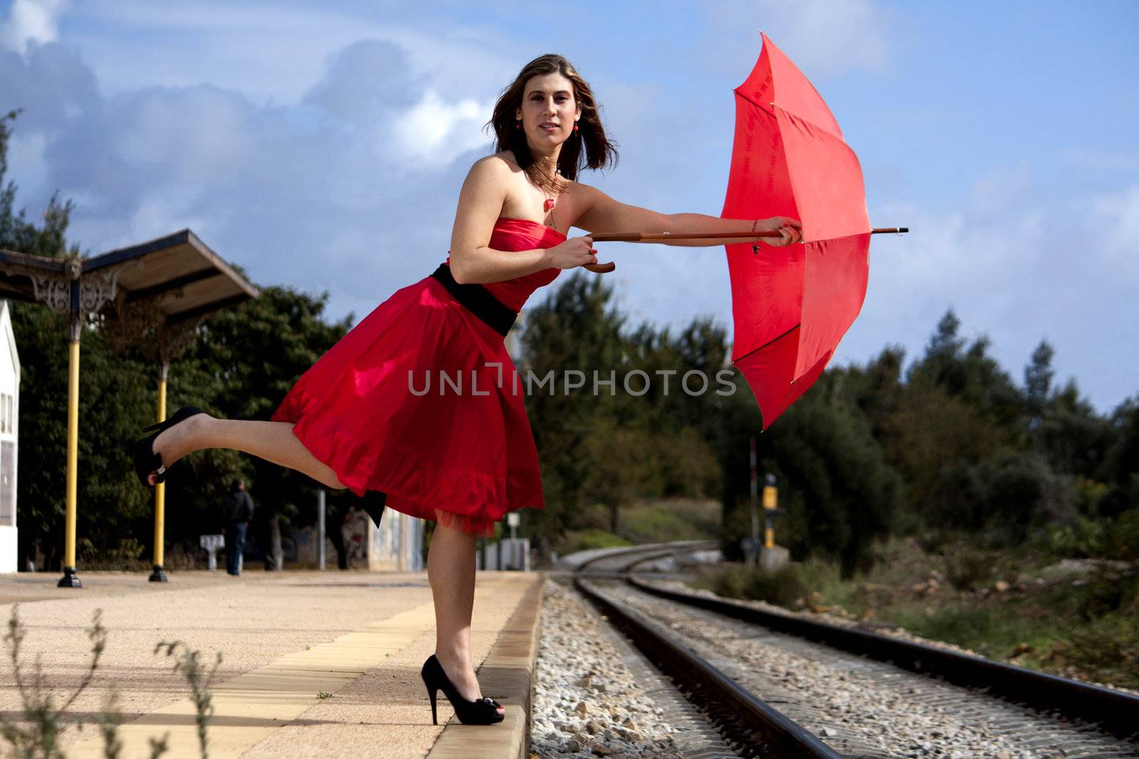 View of a beautiful woman with red dress and umbrella