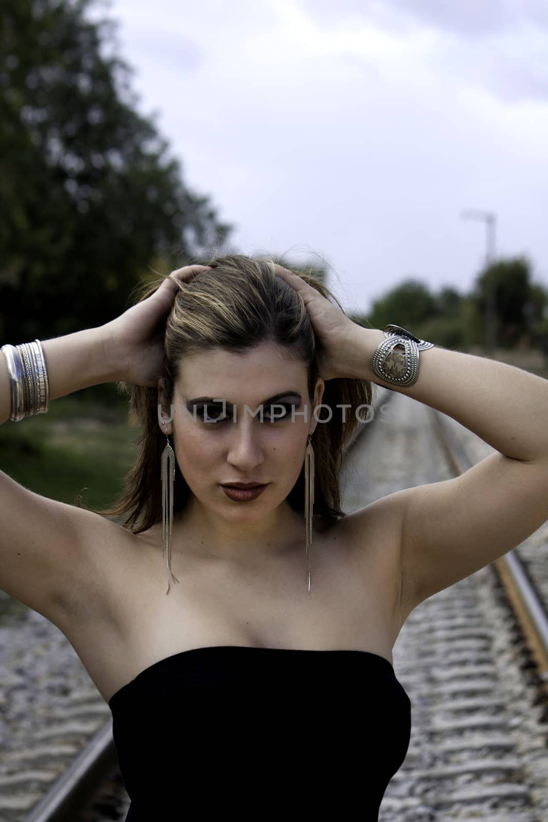 View of a beautiful woman with black dress and on a fashion pose.