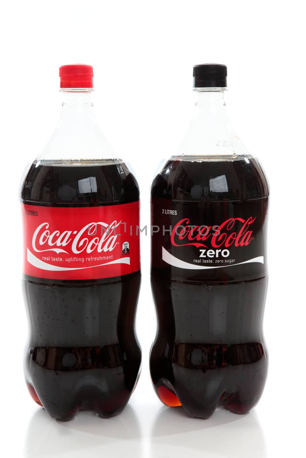Bottles of Coca-Cola and Coke Zero, diet cola, caffeine flavoured carbonated drinks,soda drinks on a white background.