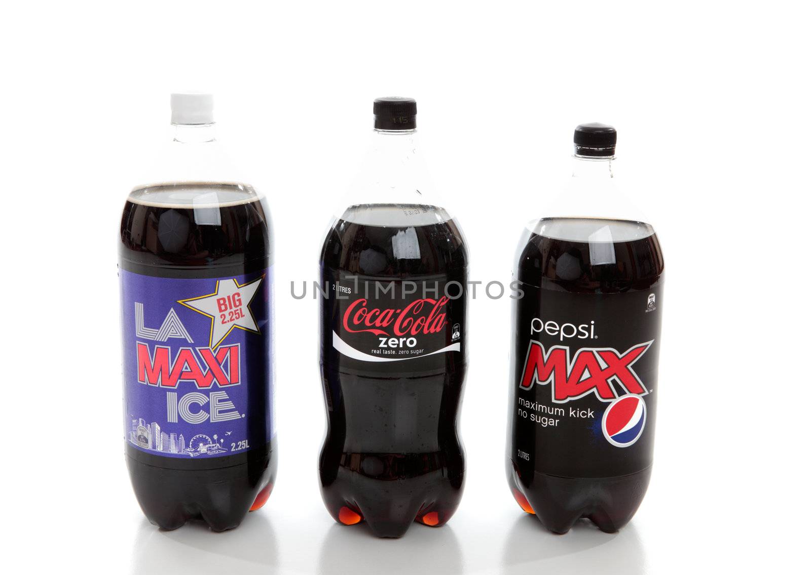 A selection of three bottled diet cola softdrinks.  LA Maxi Ice, Pepsi Max and Coke Zero.  White background.  EDITORIAL USE ONLY.