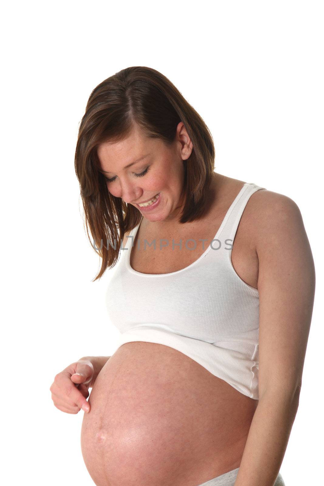 Pregnant woman shows her belly on - is the side - in front of white background
