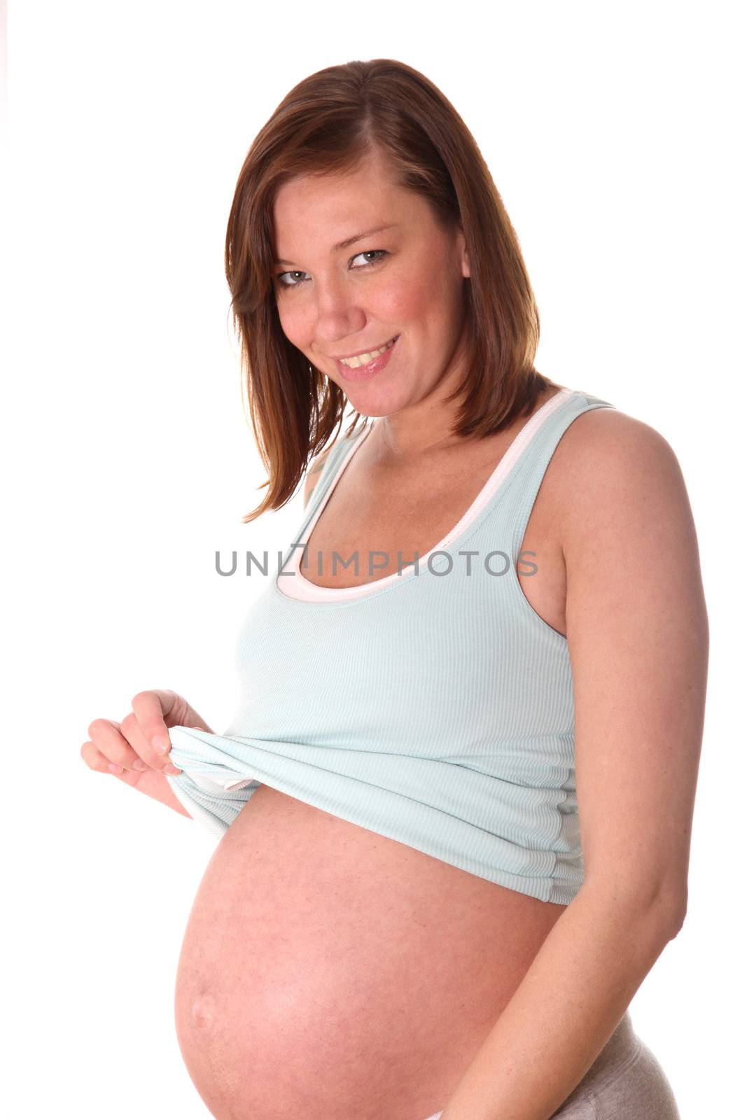 young, pregnant woman smiles at the camera
