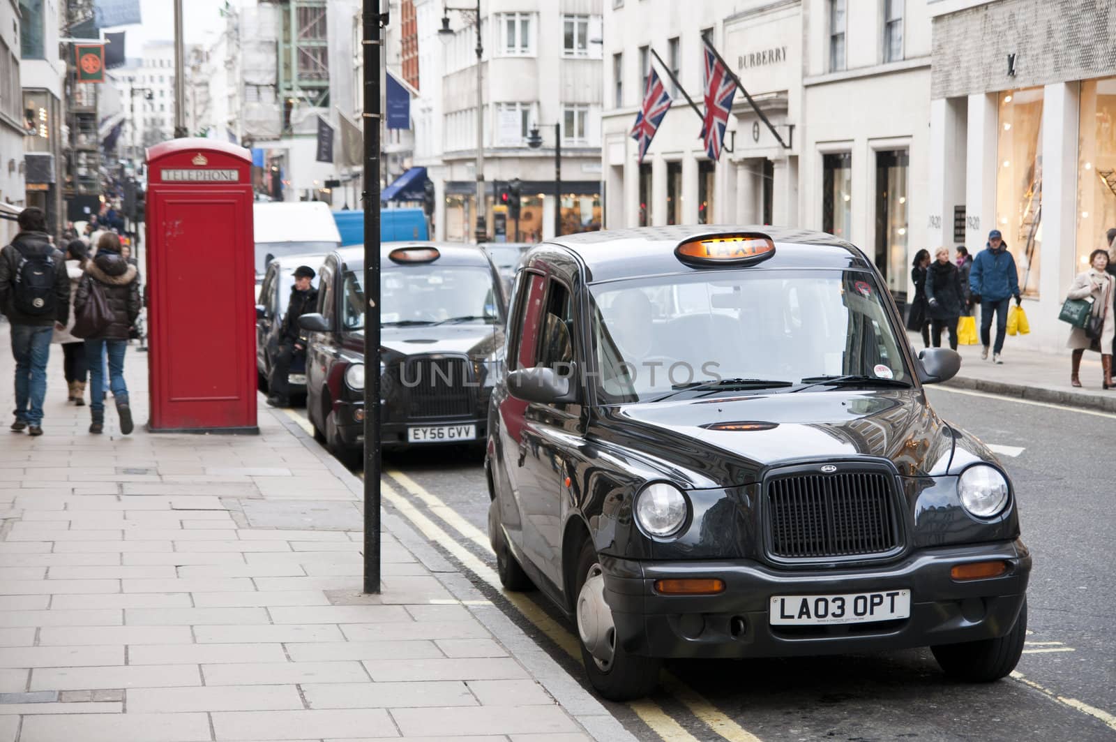 LONDON - FEBRUARY 04: Traditional black cabs parked in New Bond Street, one of the most expensive areas in London, home to fine art galleries and auction houses such as Sothebys. February 04, 2011 in London, England.
