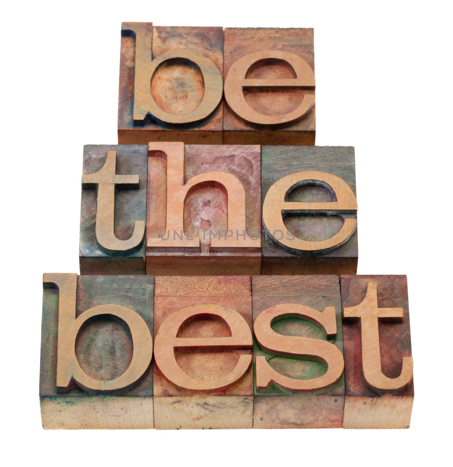 be the best - slogan in vintage wooden letterpress prititng blocks, stained by color inks, isolated on white