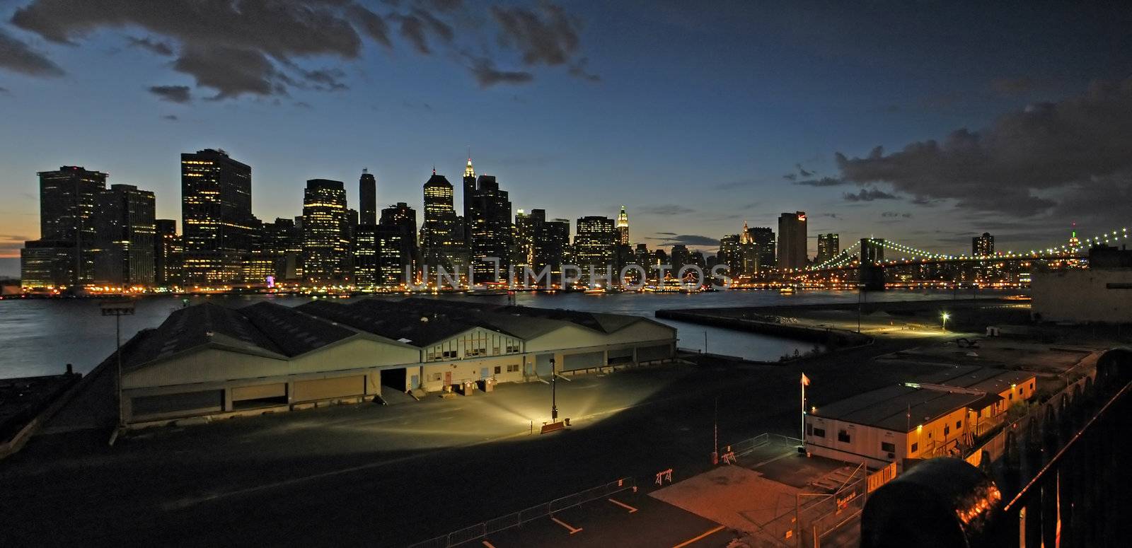 night panorama photo of new york brooklyn bridge in background