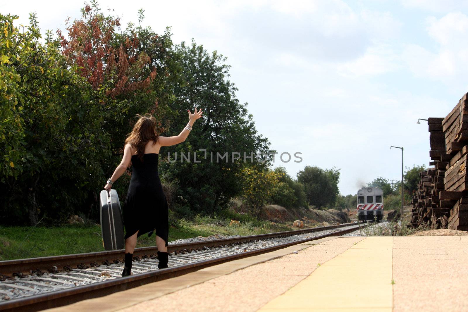 View of a beautiful woman with black dress upset with not catching the train
