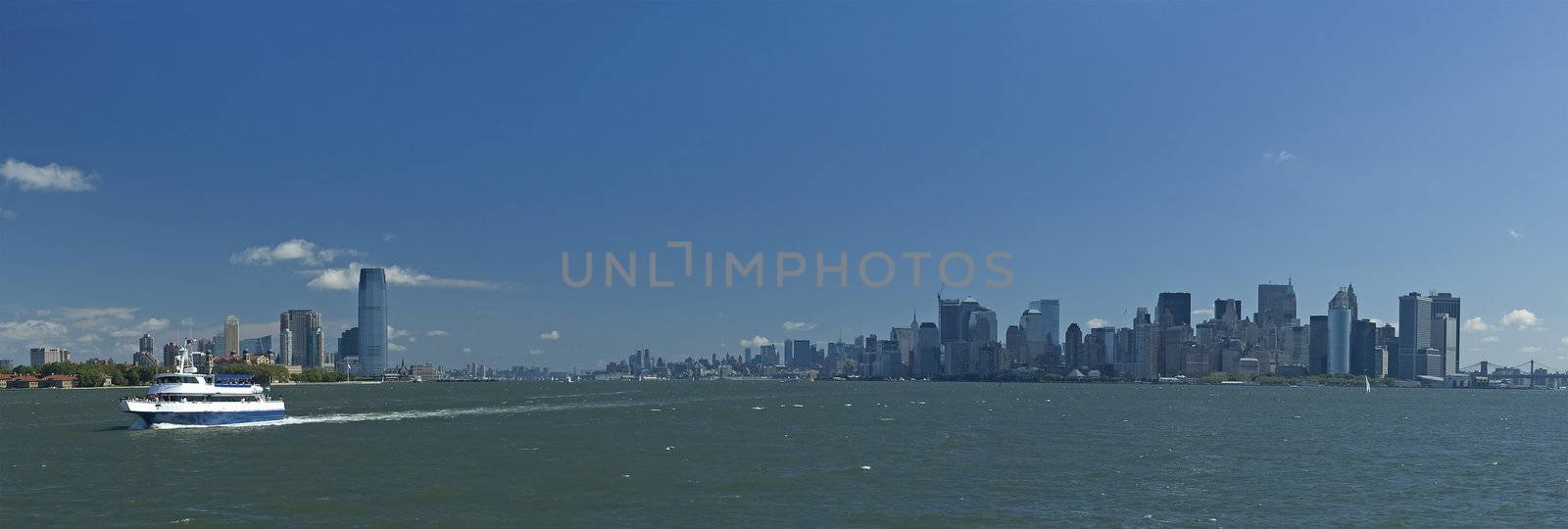 white boat going from nyc to statue of liberty, panorama photo