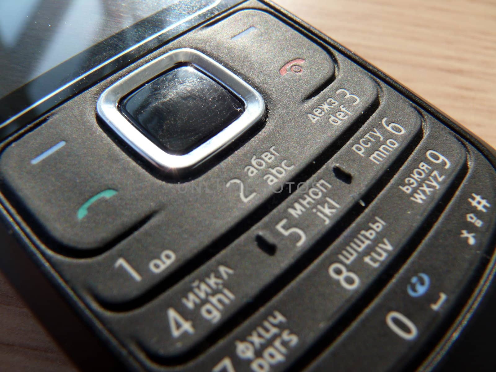 Cellular phone in wooden background