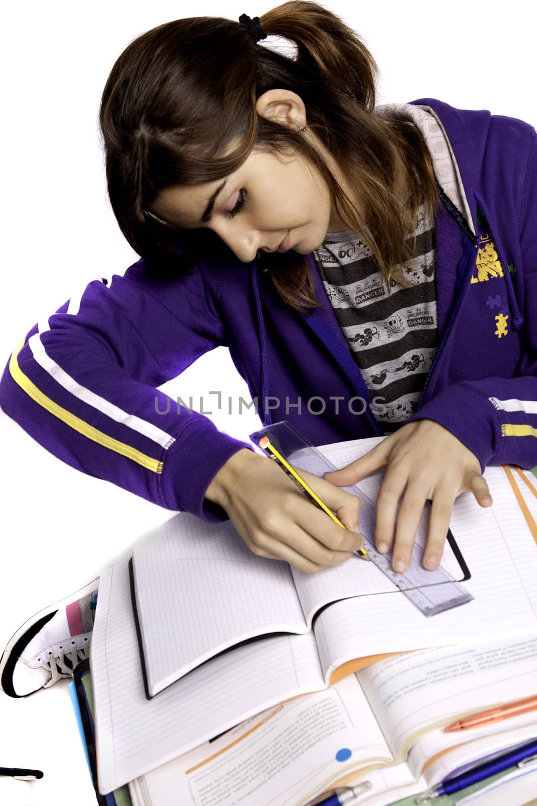 View of a teenager school girl studying on a white background.