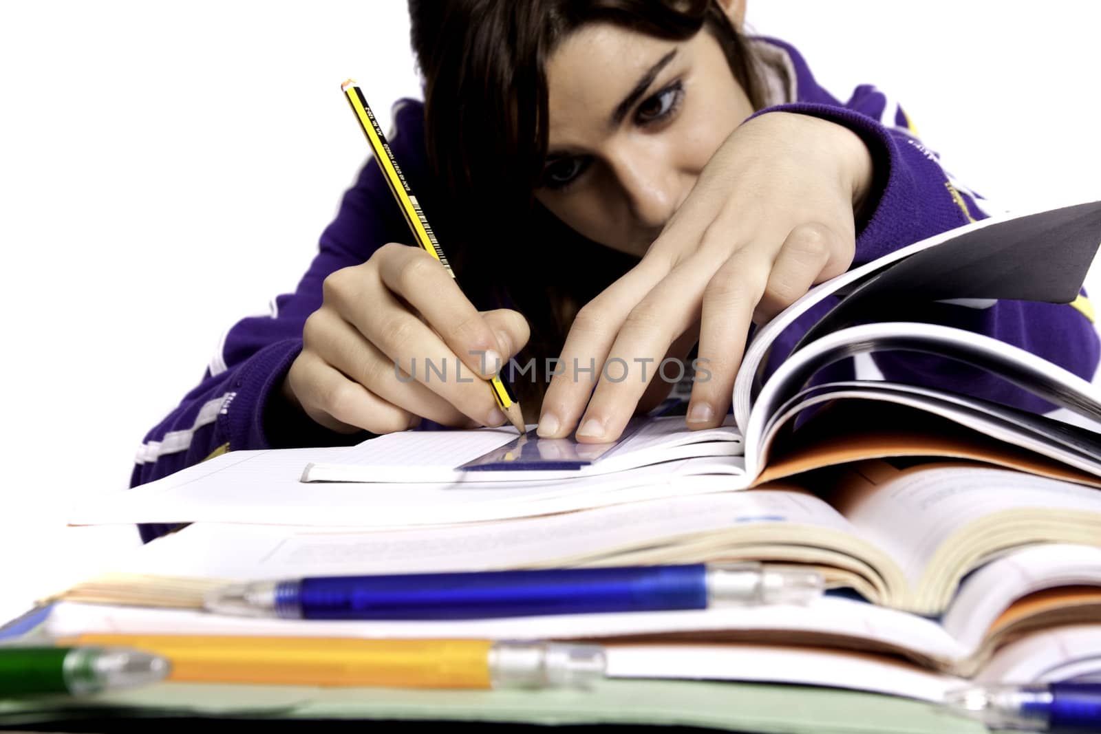 View of a teenager school girl studying on a white background.