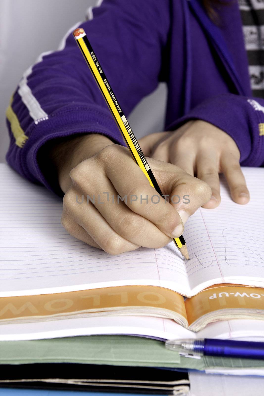 Close up view of a teenager school girl studying the books.