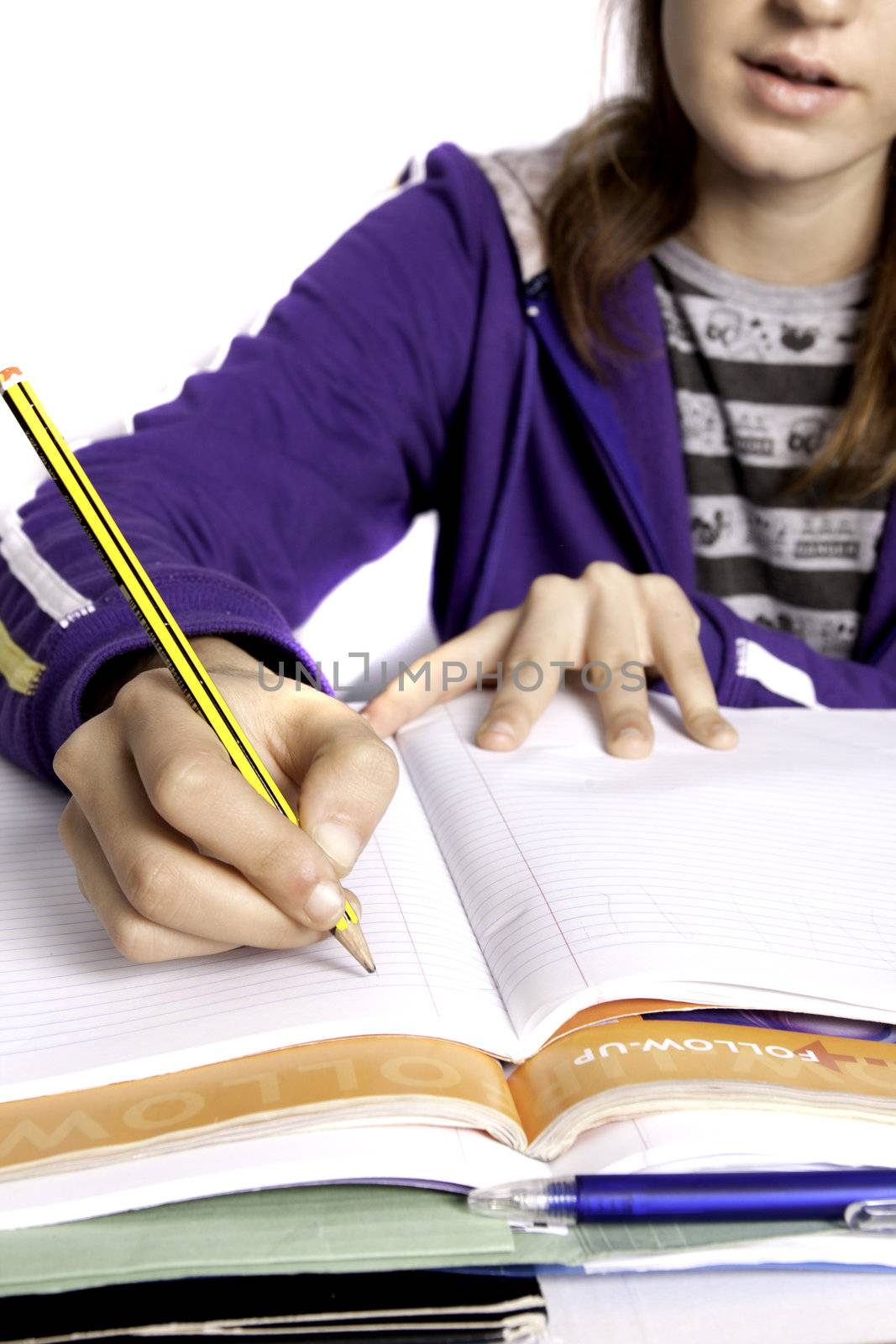 Close up view of a teenager school girl studying the books.