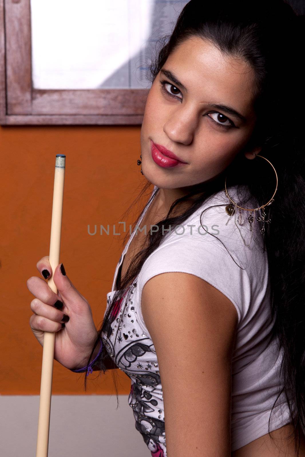 Detail view of a girl next to a snooker table.