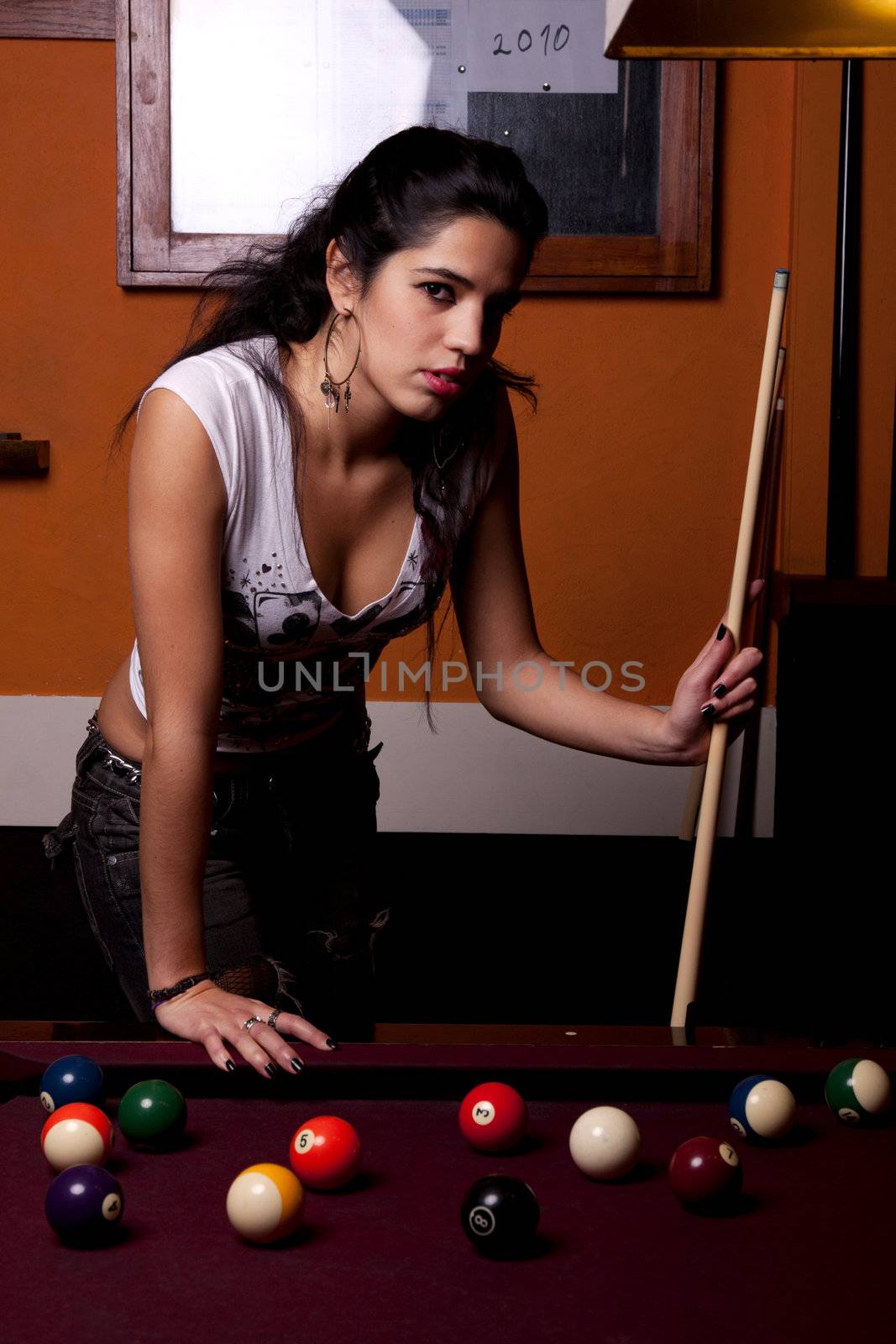 Detail view of a girl next to a snooker table.