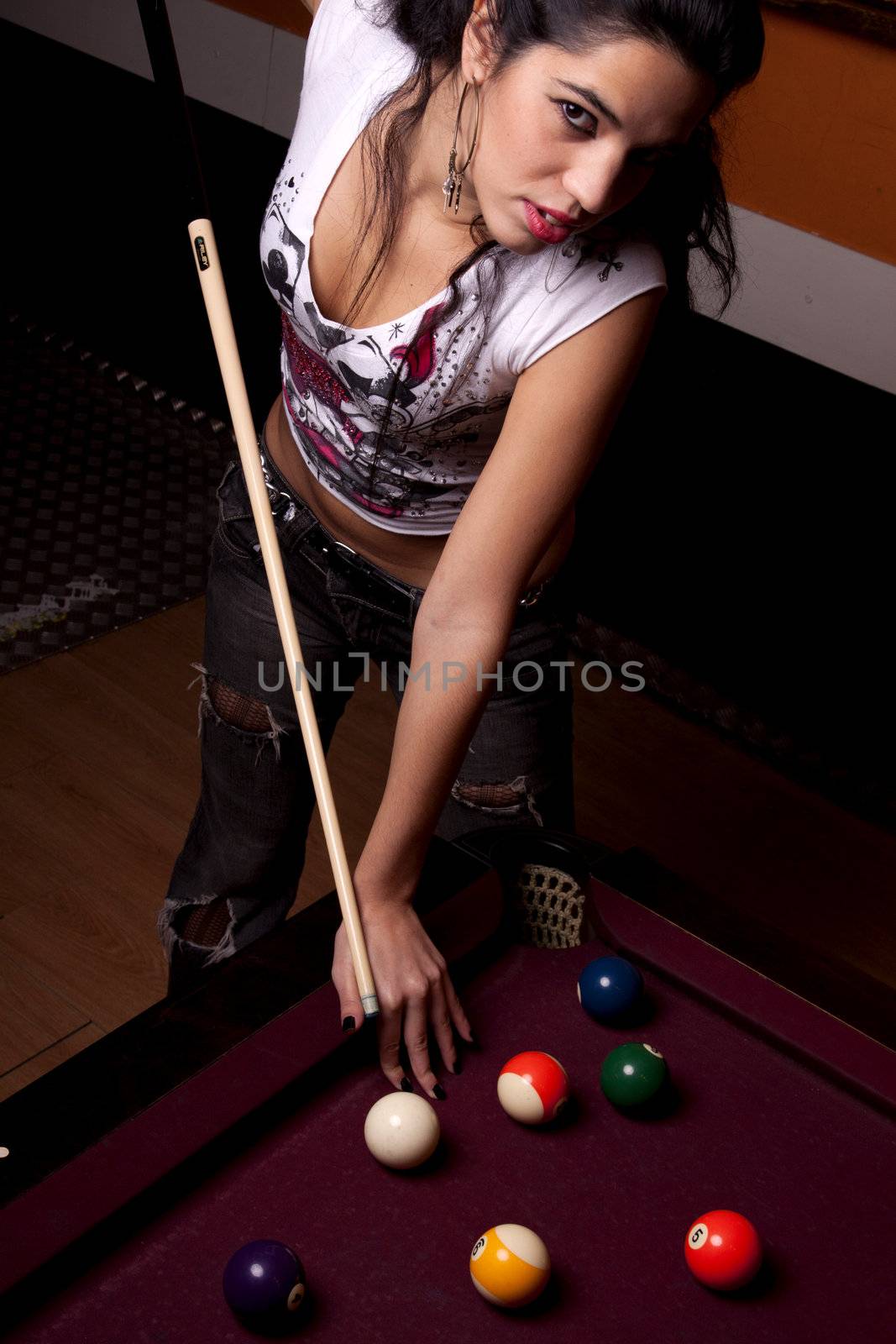 Detail view of a girl next to a snooker table.