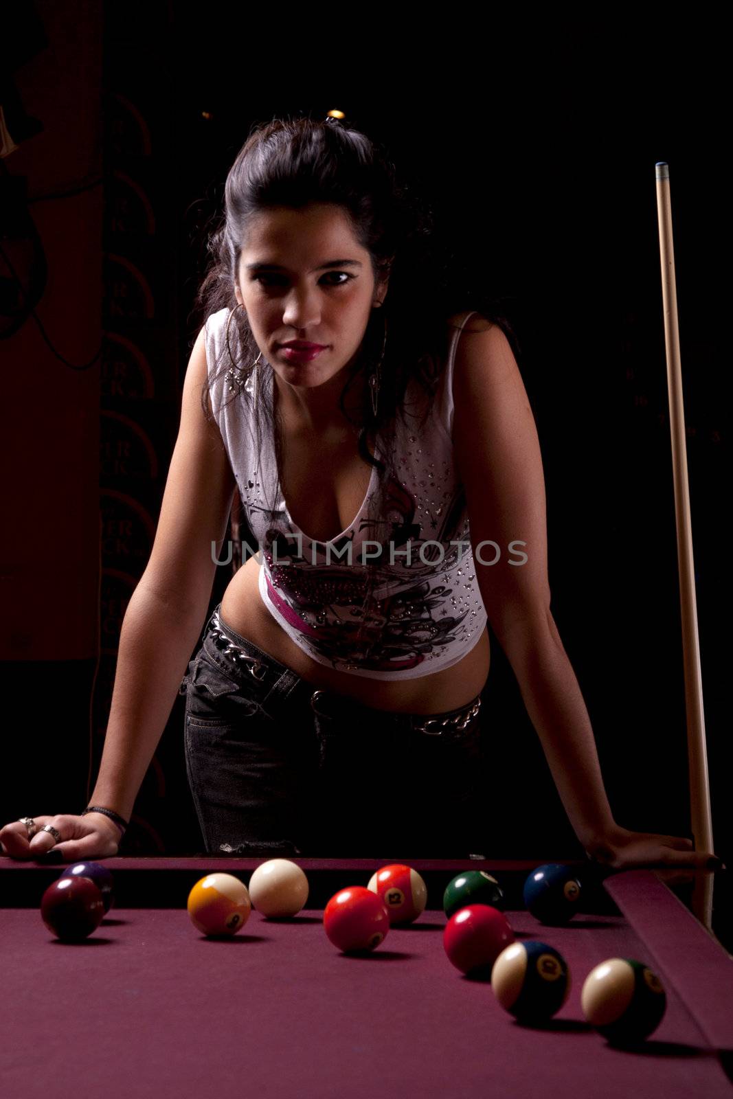 Detail view of a girl next to a snooker table.