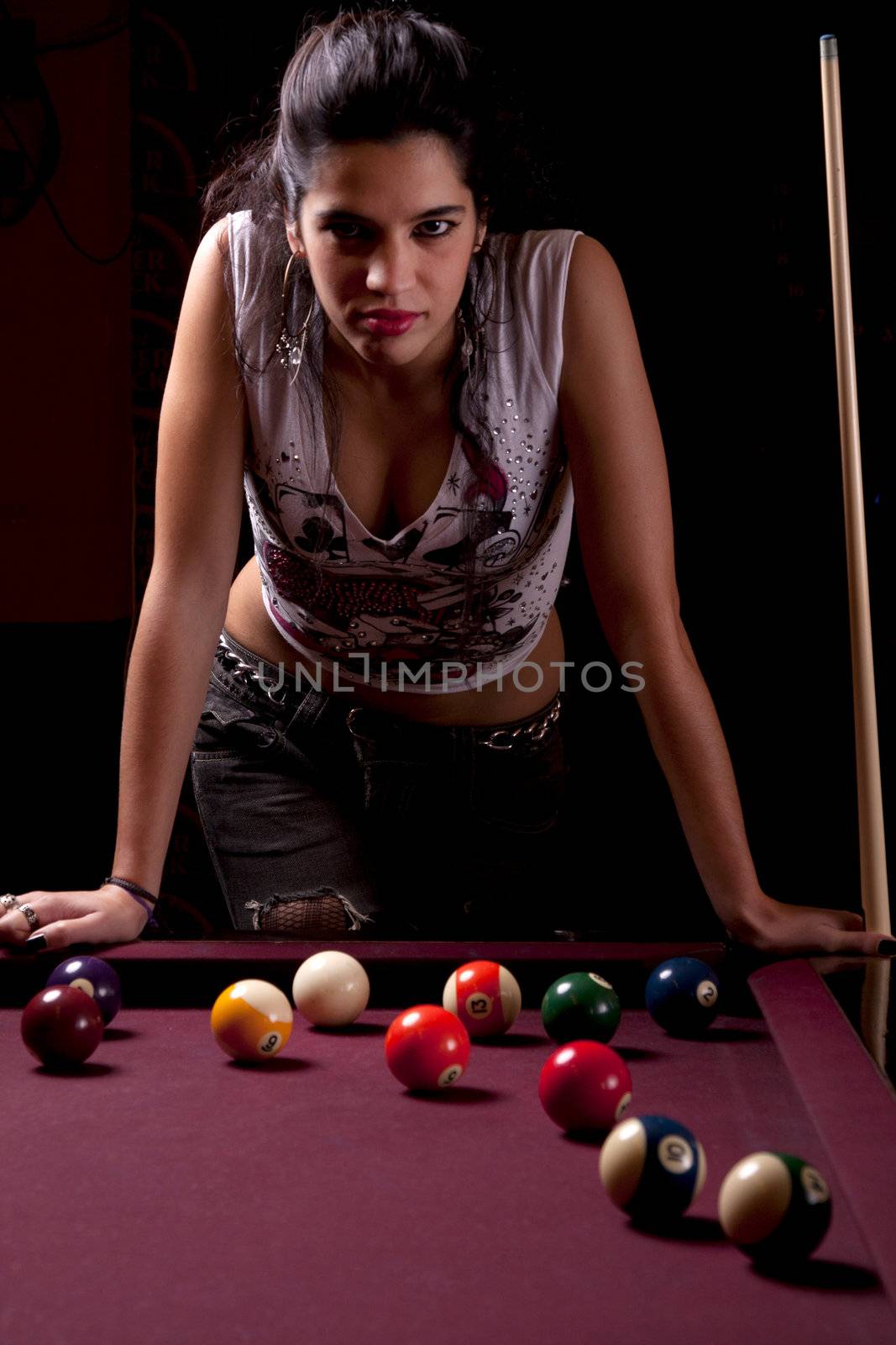 Detail view of a girl next to a snooker table.