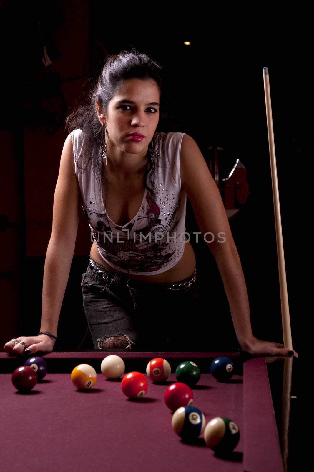 Detail view of a girl next to a snooker table.