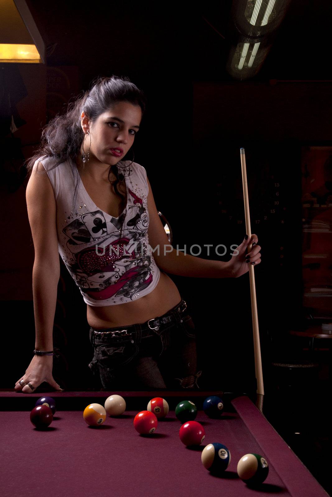Detail view of a girl next to a snooker table.