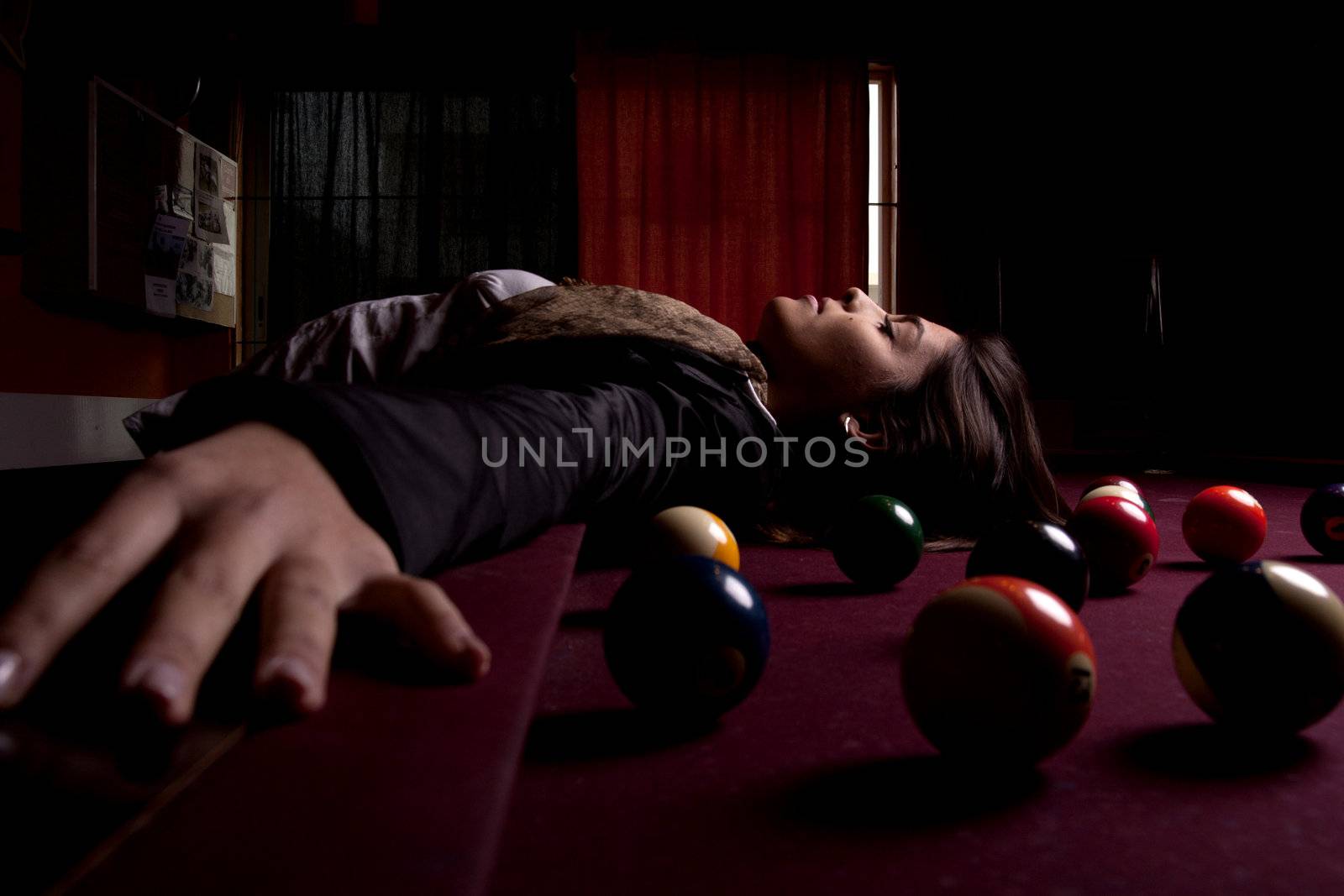 Detail view of a girl next to a snooker table.