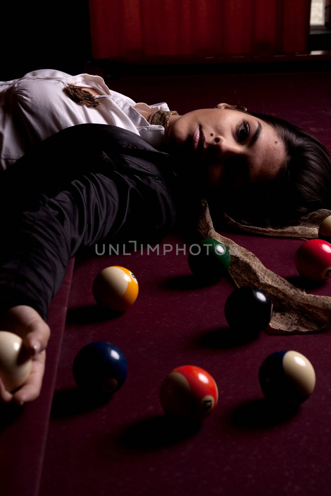 Detail view of a girl next to a snooker table.