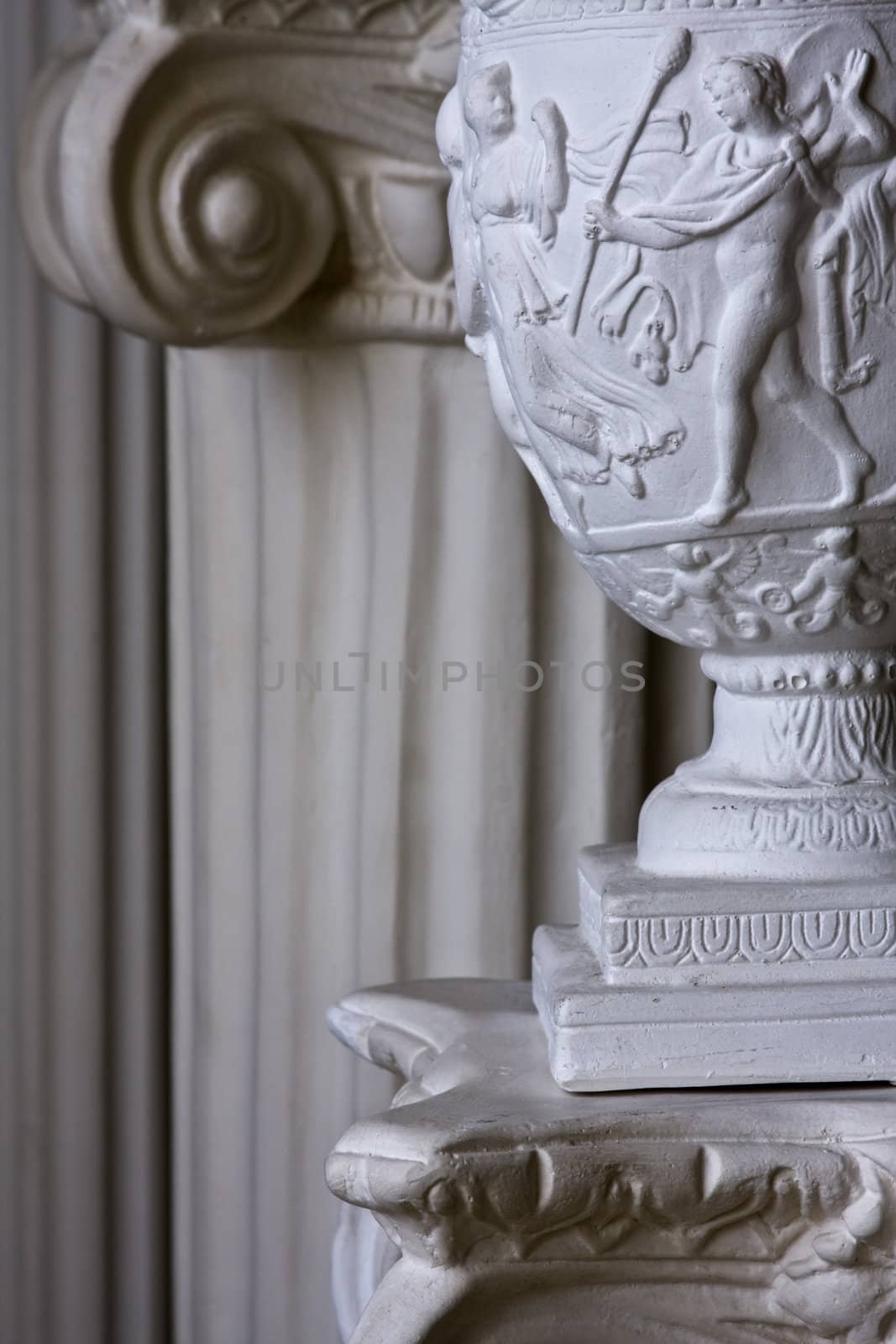 Detail of stone carving on lamp with columns on backgound and copy space