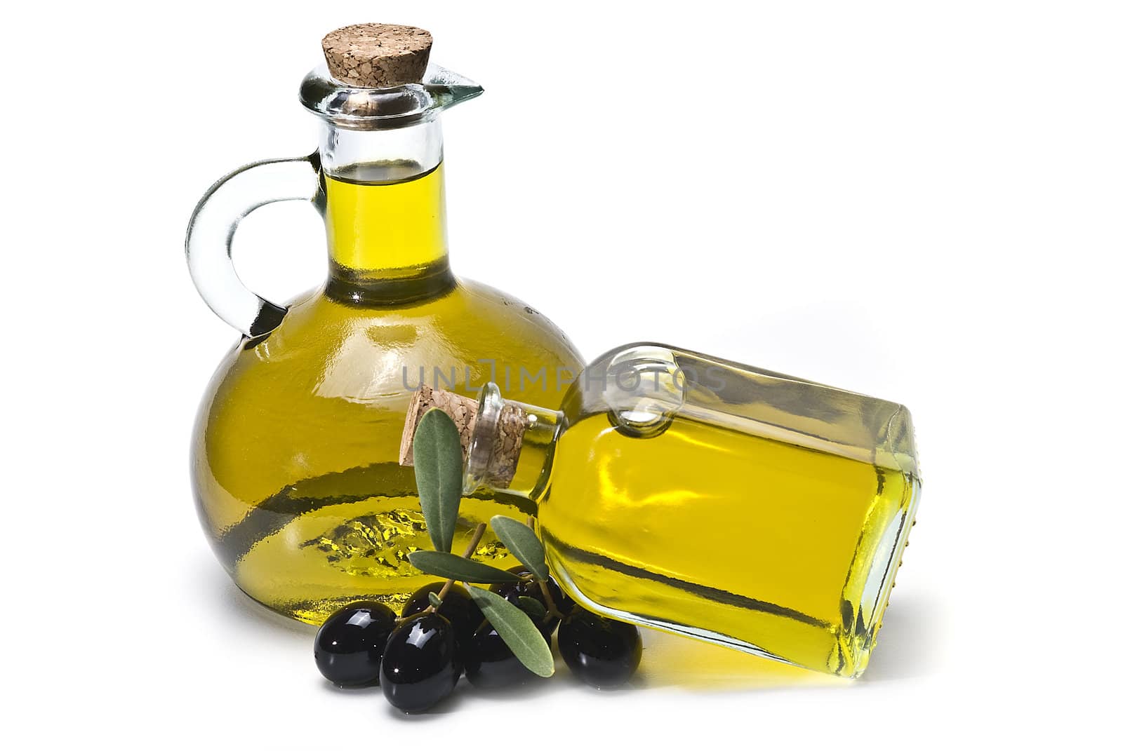 Some olives and olive oil isolated on a white background.